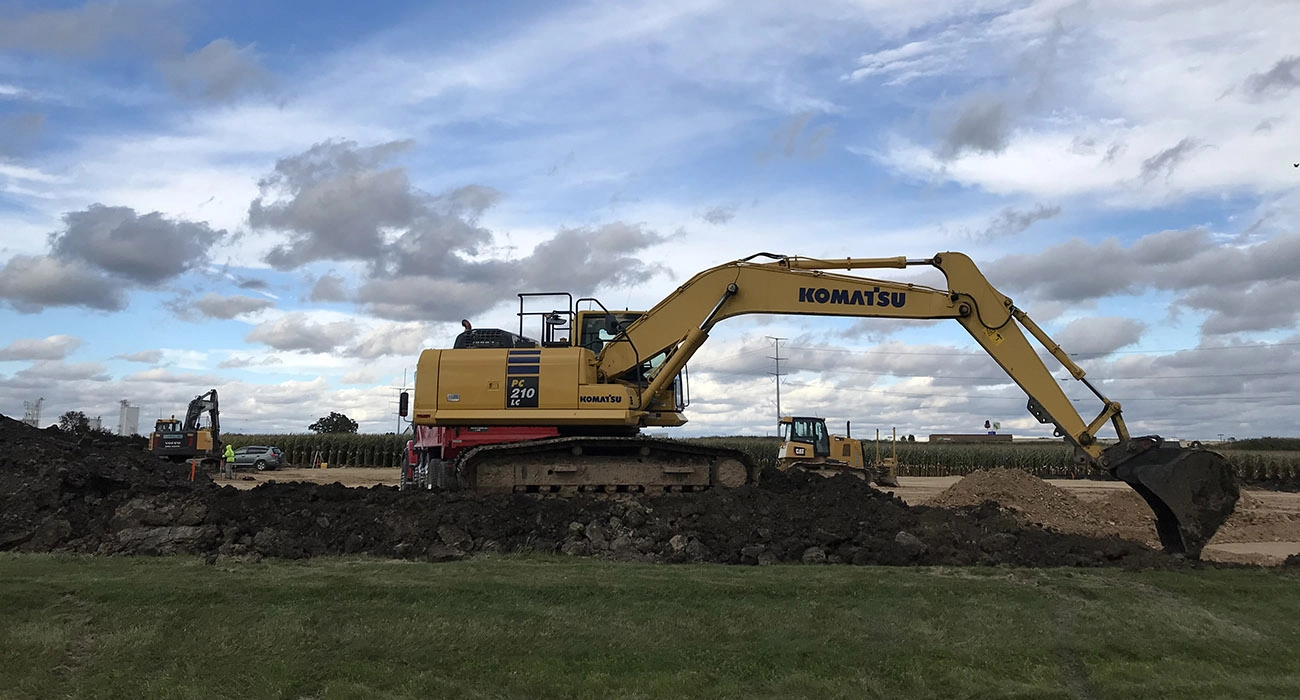 Backhoe digging dirt