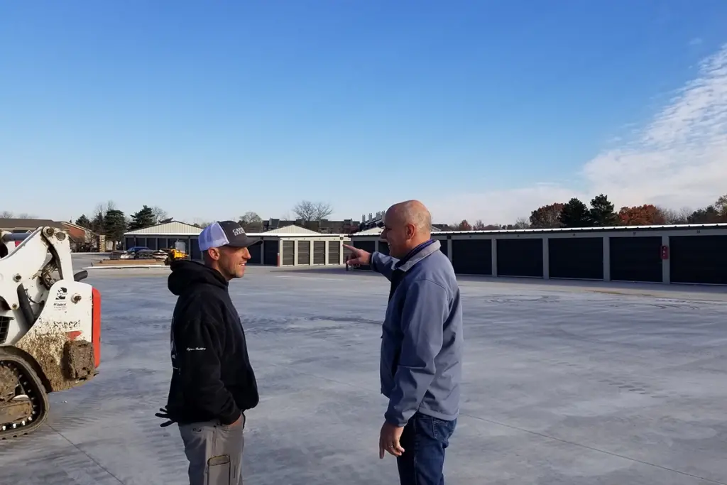 two man chatting outside storage facility